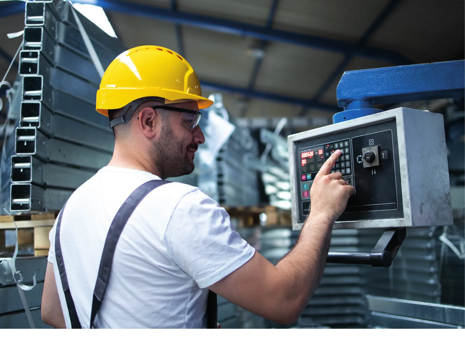 Maintenance operator using a machine control panel in an industrial facility